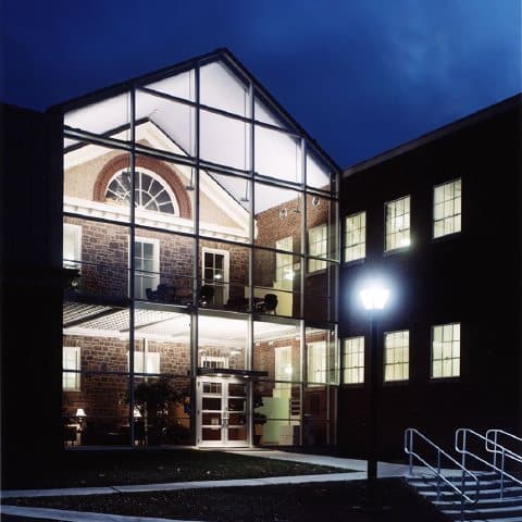 chancellor glass entrance night view - Bucks County Beacon - Council Rock School District’s Historic Chancellor Center Faces an Uncertain Future