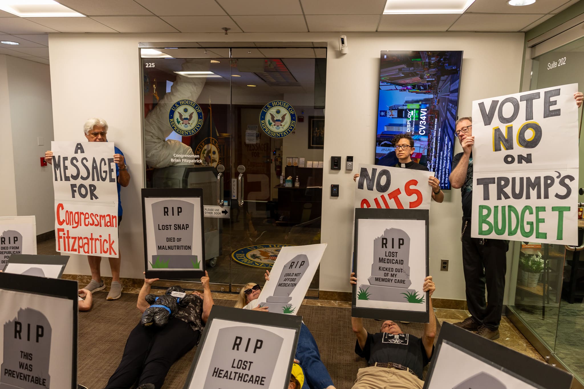 Indivisible DIE IN 1 - Bucks County Beacon - PHOTO ESSAY: Hundreds Participate in Die-in at Congressman Brian Fitzpatrick’s Office to Highlight Deadly Stakes of GOP Budget