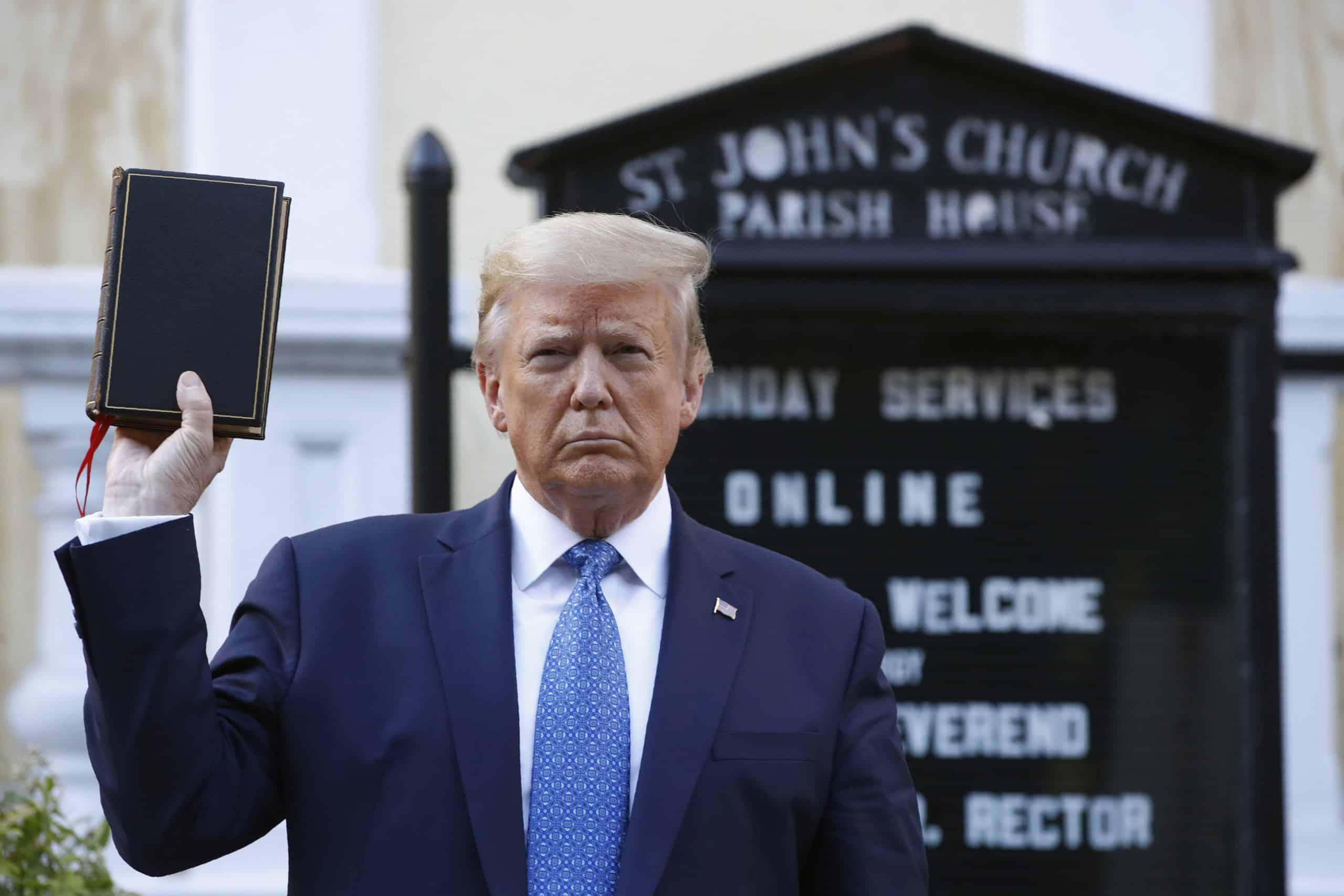 Trump Holds Bible scaled - Bucks County Beacon - ‘Plunging Houses of Worship Into Partisan Battles’: The Trump Administration’s Determination to Rewrite the Johnson Amendment