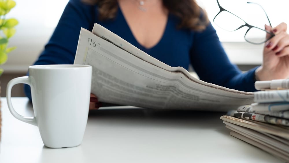 Woman Reading Newspaper - Bucks County Beacon - OPINION: Why Local News Still Matters in Bucks County