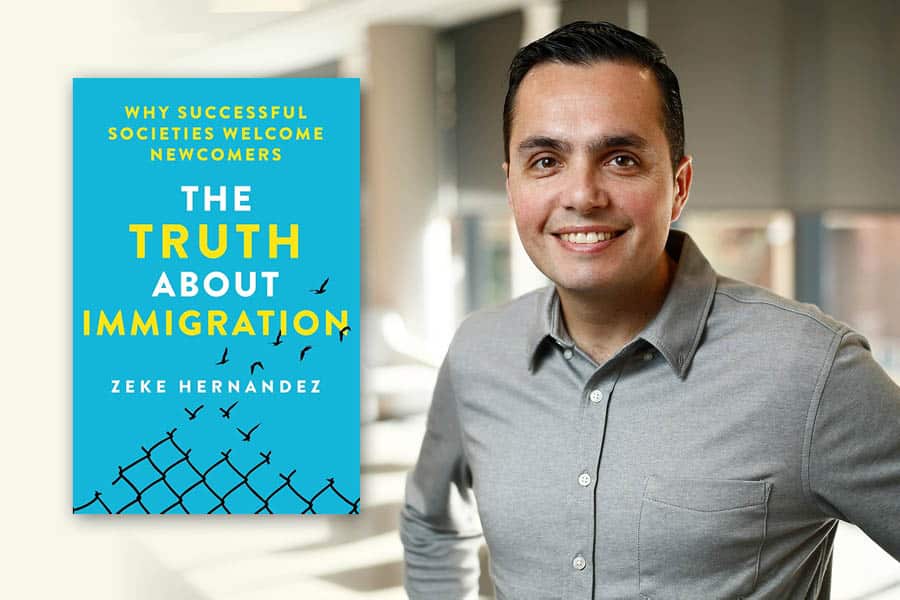 Professor Zeke Hernandez with his book "The Truth About Immigration: