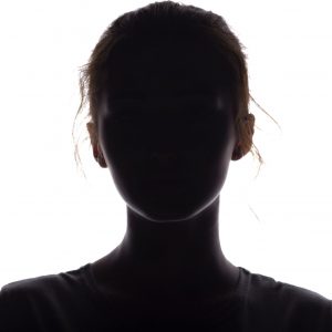 silhouette of a beautiful girl confidently looking forward, a young woman's head with a curl on a white isolated background